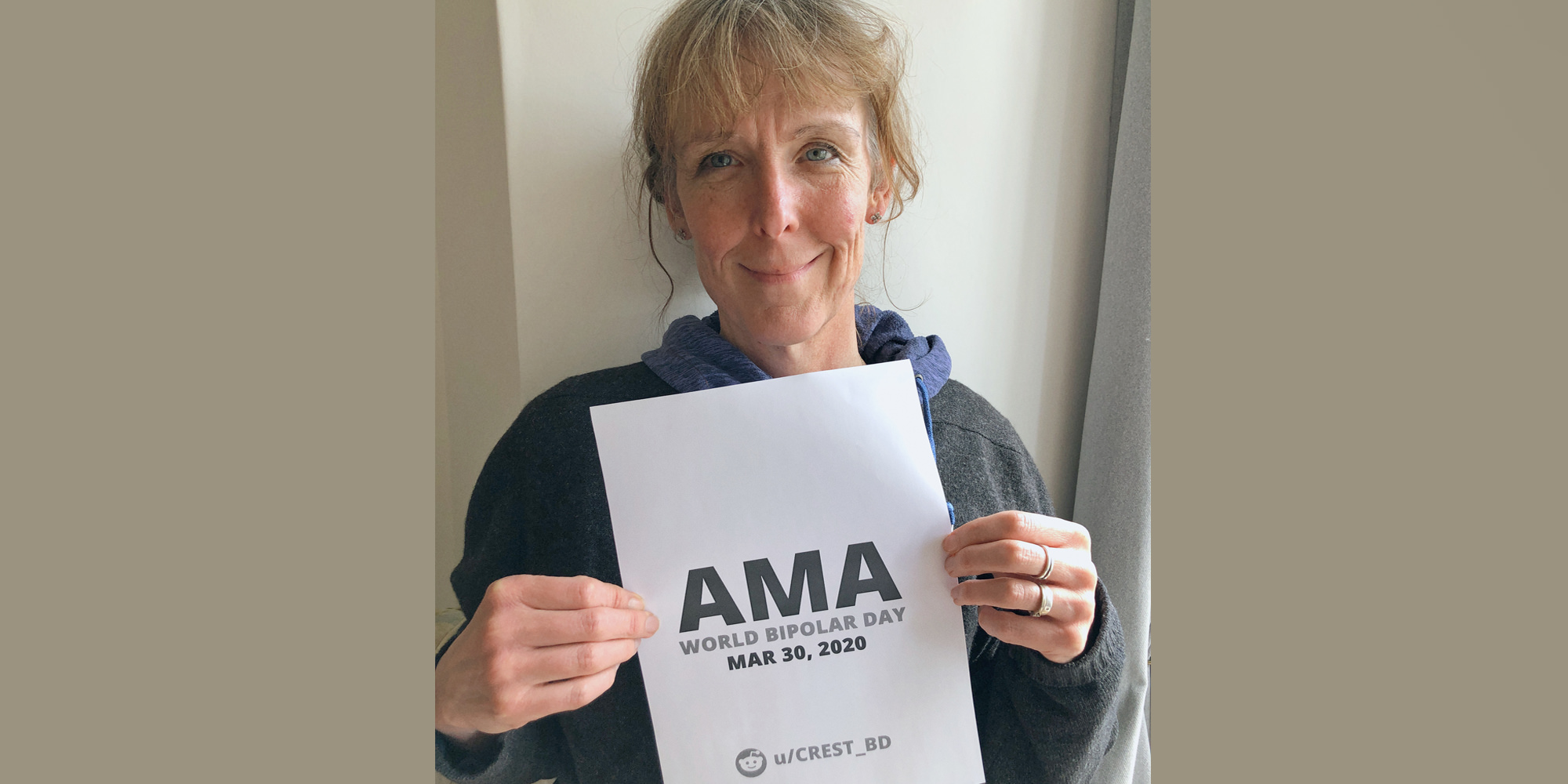 Fiona smiling warmly and holding a proof sign.