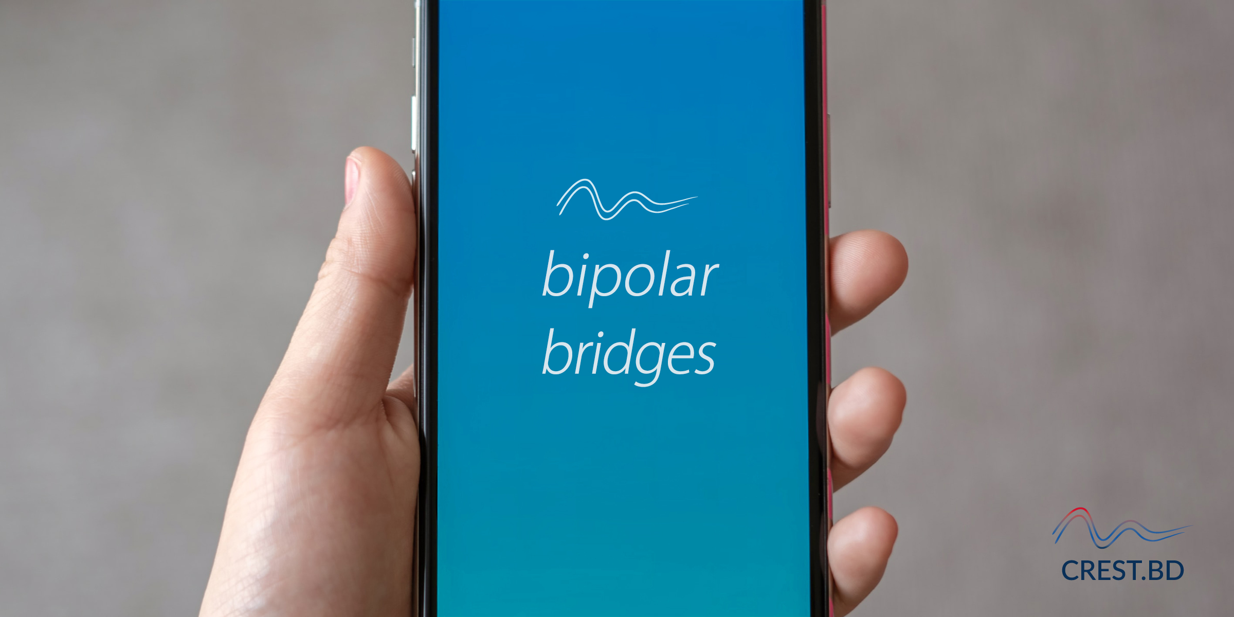 A close-up of a mobile phone is held in a white person's hand. The words 'bipolar bridges' are shown on the screen, with the CREST.BD two waves above it. The phone background is a blue gradient. 