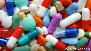 Photo of various medication pills in red, turquoise, purple and white.