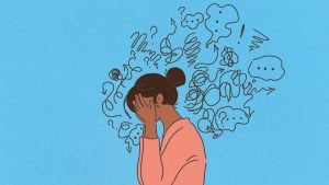 Image is on a blue background. A woman with a pink shirt and black hair in a bun rests her face in her hands. Surrounding her are lines and doodles indicating her anxiety and distress.
